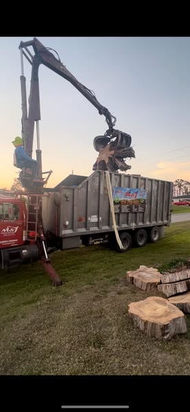 Grapple truck removing large stump